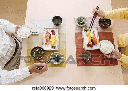 Stock Photo - Senior adult Japanese couple in the kitchen. Fotosearch