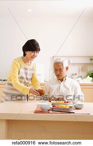 Senior adult Japanese couple in the kitchen View Large Photo Image Stock Photograph - Senior adult Japanese couple in the kitchen. Fotosearch