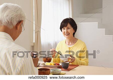 Stock Photography - Senior adult Japanese couple in the kitchen. Fotosearch