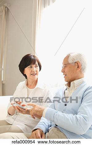 Senior adult Japanese couple on the sofa View Large Photo Image Picture - Senior adult Japanese couple on the sofa. Fotosearch
