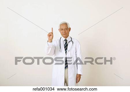 Senior adult Japanese doctor against white wall View Large Photo Image Picture - Senior adult Japanese doctor against white wall. Fotosearch