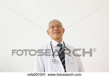 Senior adult Japanese doctor against white wall View Large Photo Image Stock Image - Senior adult Japanese doctor against white wall. Fotosearch
