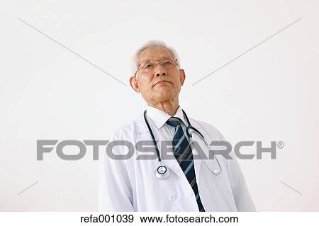 Stock Photo - Senior adult Japanese doctor against white wall. Fotosearch