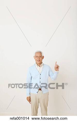 Senior adult Japanese man against white wall View Large Photo Image Picture - Senior adult Japanese man against white wall. Fotosearch