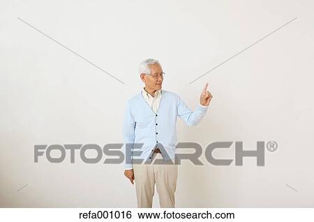 Senior adult Japanese man against white wall View Large Photo Image Stock Photograph - Senior adult Japanese man against white wall. Fotosearch