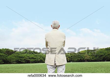 Picture - Senior adult Japanese man in a park. Fotosearch