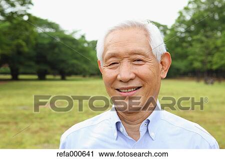 Stock Image - Senior adult Japanese man in a park. Fotosearch