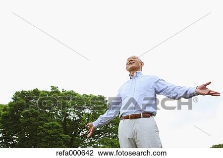Stock Image - Senior adult Japanese man in a park. Fotosearch