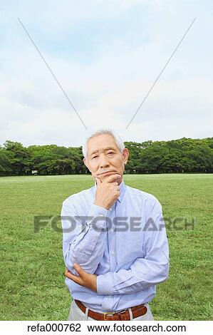 Senior adult Japanese man in a park View Large Photo Image Stock Image - Senior adult Japanese man in a park. Fotosearch