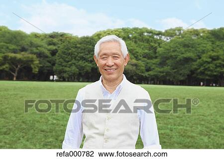 Stock Image - Senior adult Japanese man in a park. Fotosearch