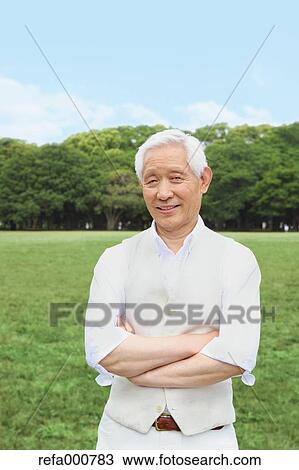 Stock Image - Senior adult Japanese man in a park. Fotosearch