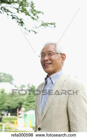 Senior adult Japanese man in a park View Large Photo Image Stock Photo - Senior adult Japanese man in a park. Fotosearch