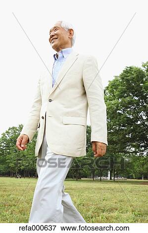 Stock Photo - Senior adult Japanese man in a park. Fotosearch