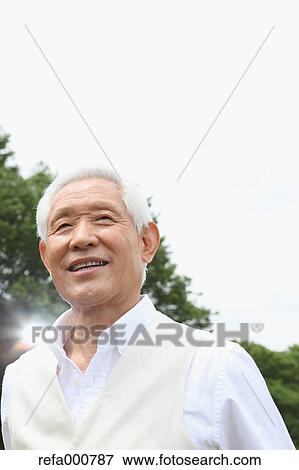 Stock Photo - Senior adult Japanese man in a park. Fotosearch