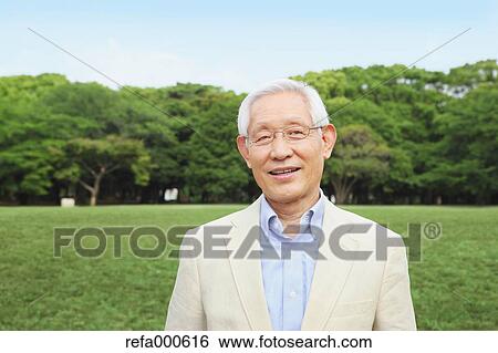 Stock Photograph - Senior adult Japanese man in a park. Fotosearch
