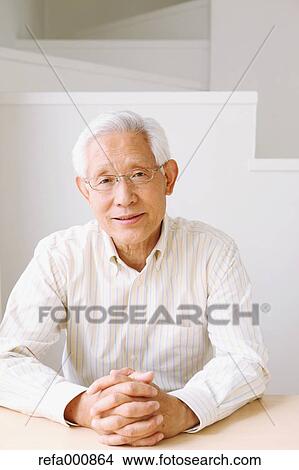 Picture - Senior adult Japanese man sitting. Fotosearch