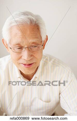 Stock Photo - Senior adult Japanese man sitting. Fotosearch