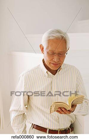 Senior adult Japanese man with book View Large Photo Image Stock Image - Senior adult Japanese man with book. Fotosearch