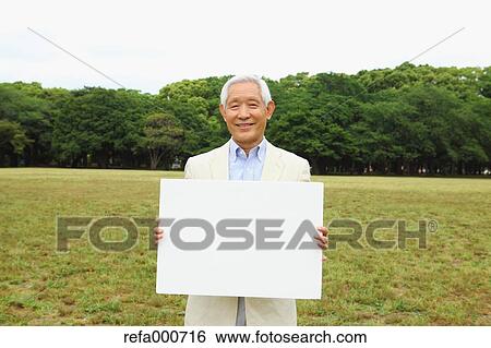 Senior adult Japanese man with whiteboard in a park View Large Photo Image Stock Photograph - Senior adult Japanese man with whiteboard in a park. Fotosearch