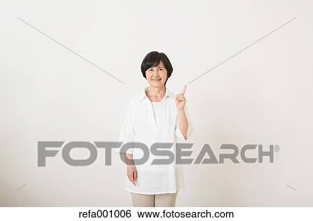 Senior adult Japanese woman against white wall View Large Photo Image Stock Photograph - Senior adult Japanese woman against white wall. Fotosearch