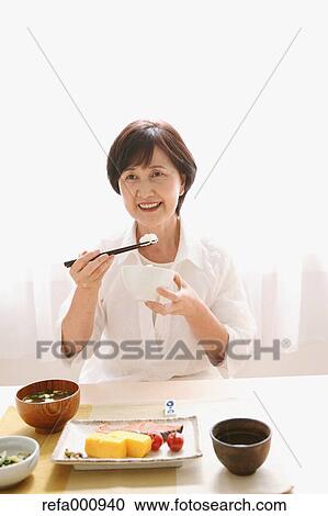 Senior adult Japanese woman eating View Large Photo Image Stock Image - Senior adult Japanese woman eating. Fotosearch