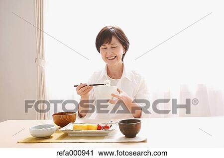 Senior adult Japanese woman eating View Large Photo Image Stock Image - Senior adult Japanese woman eating. Fotosearch