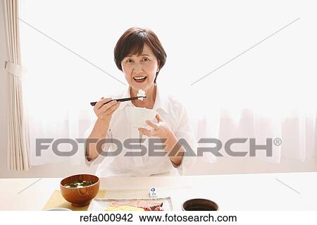 Senior adult Japanese woman eating View Large Photo Image Stock Image - Senior adult Japanese woman eating. Fotosearch