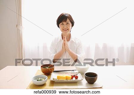 Stock Photo - Senior adult Japanese woman eating. Fotosearch