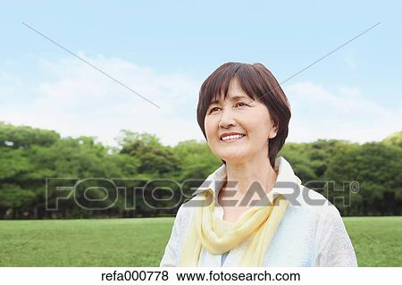 Senior adult Japanese woman in a park View Large Photo Image Stock Photo - Senior adult Japanese woman in a park. Fotosearch
