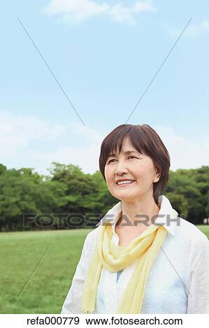 Stock Photo - Senior adult Japanese woman in a park. Fotosearch