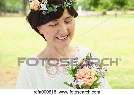 Stock Photo - Senior adult Japanese woman in a park. Fotosearch