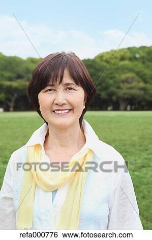 Stock Photograph - Senior adult Japanese woman in a park. Fotosearch