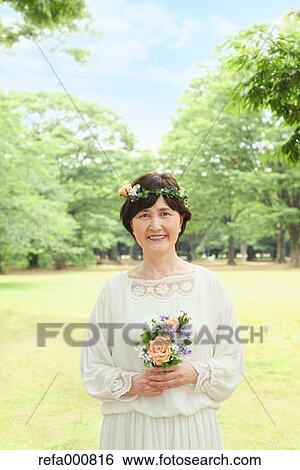 Senior adult Japanese woman in a park View Large Photo Image Stock Photograph - Senior adult Japanese woman in a park. Fotosearch