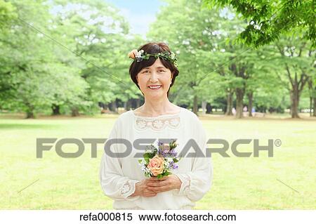 Stock Photography - Senior adult Japanese woman in a park. Fotosearch