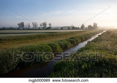 Stock Photo - Small canal in the countryside. Fotosearch