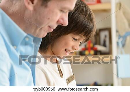 Young boy with his dad in the house View Large Photo Image Stock Photograph - Young boy with his dad in the house. Fotosearch