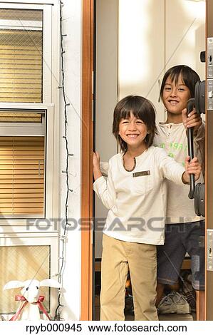 Young boys smiling at the entrance door View Large Photo Image Stock Photography - Young boys smiling at the entrance door. Fotosearch