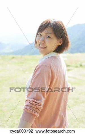 Stock Image - Young Japanese girl in the countryside. Fotosearch