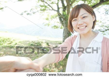 Stock Image - Young Japanese girl in the countryside. Fotosearch