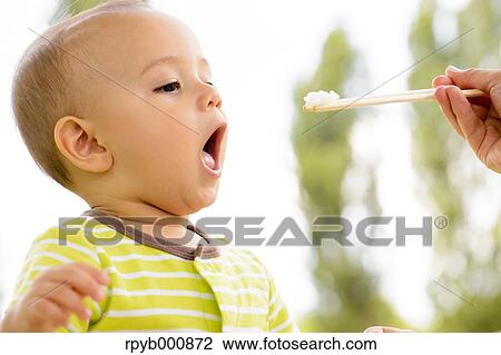 Young Japanese kid eating in a park View Large Photo Image Stock Image - Young Japanese kid eating in a park. Fotosearch