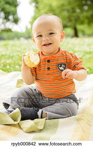 Stock Image - Young Japanese kid in a park. Fotosearch