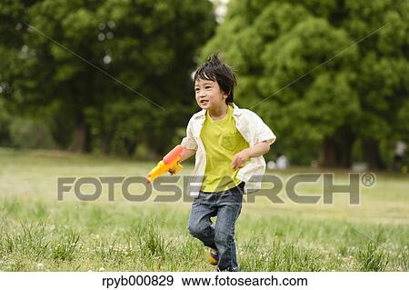 Young Japanese kid playing in a park View Large Photo Image Stock Photo - Young Japanese kid playing in a park. Fotosearch