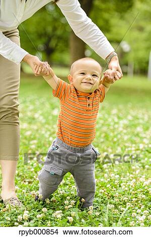 Young Japanese kid with his mum in a park View Large Photo Image Picture - Young Japanese kid with his mum in a park. Fotosearch