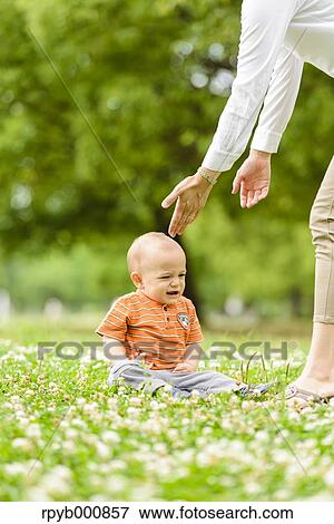 Young Japanese kid with his mum in a park View Large Photo Image Stock Photo - Young Japanese kid with his mum in a park. Fotosearch