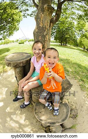 Young Japanese kids playing in a park View Large Photo Image Stock Image - Young Japanese kids playing in a park. Fotosearch