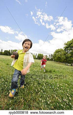 Young Japanese kids playing in a park View Large Photo Image Stock Photo - Young Japanese kids playing in a park. Fotosearch