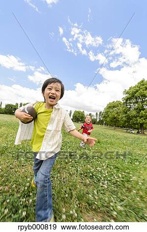 Young Japanese kids playing in a park View Large Photo Image Stock Photo - Young Japanese kids playing in a park. Fotosearch
