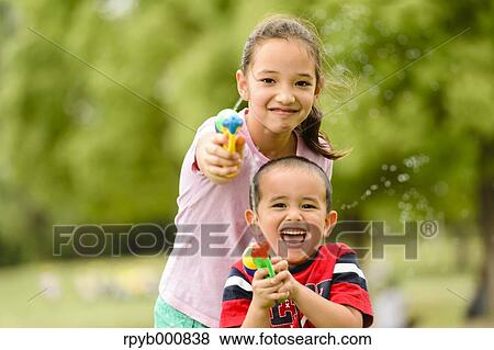 Young Japanese kids playing in a park View Large Photo Image Stock Photo - Young Japanese kids playing in a park. Fotosearch