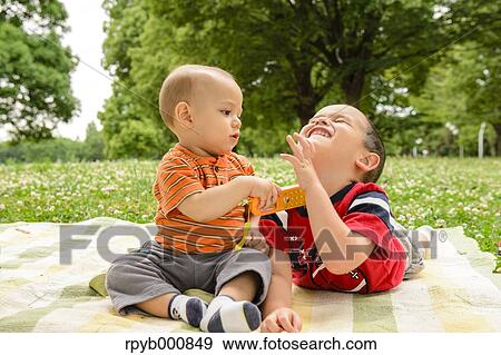 Young Japanese kids playing in a park View Large Photo Image Stock Photo - Young Japanese kids playing in a park. Fotosearch
