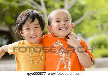 Stock Photo - Young Japanese kids playing in a park. Fotosearch